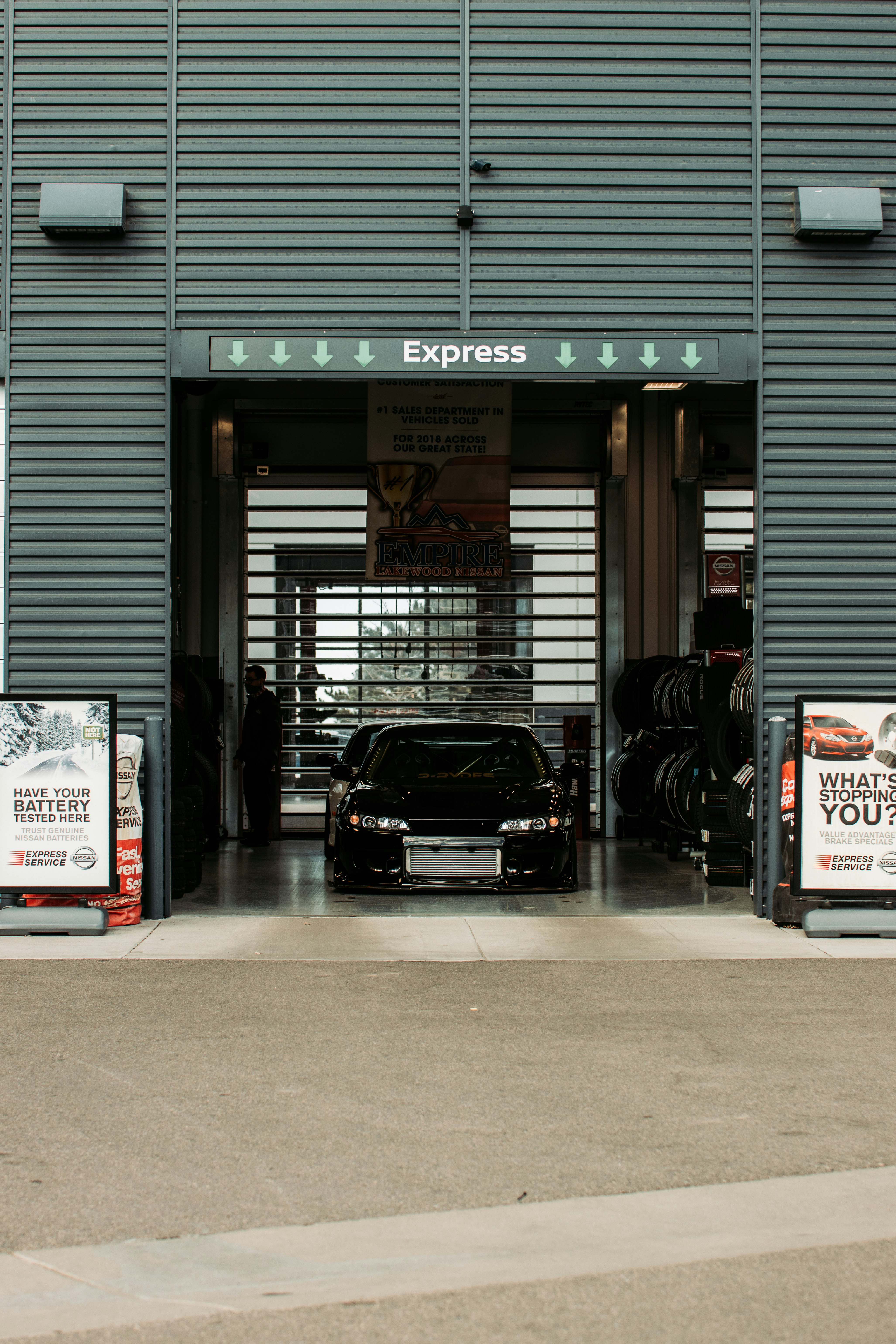 black car parked in front of store